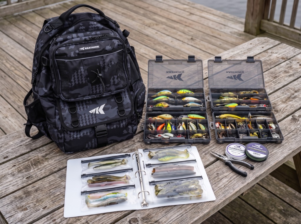 KastKing BaitSpace 50L Fishing Backpack complete loadout showing black digital camo pack with four 3600 trays and ring-bound soft plastic bait binder